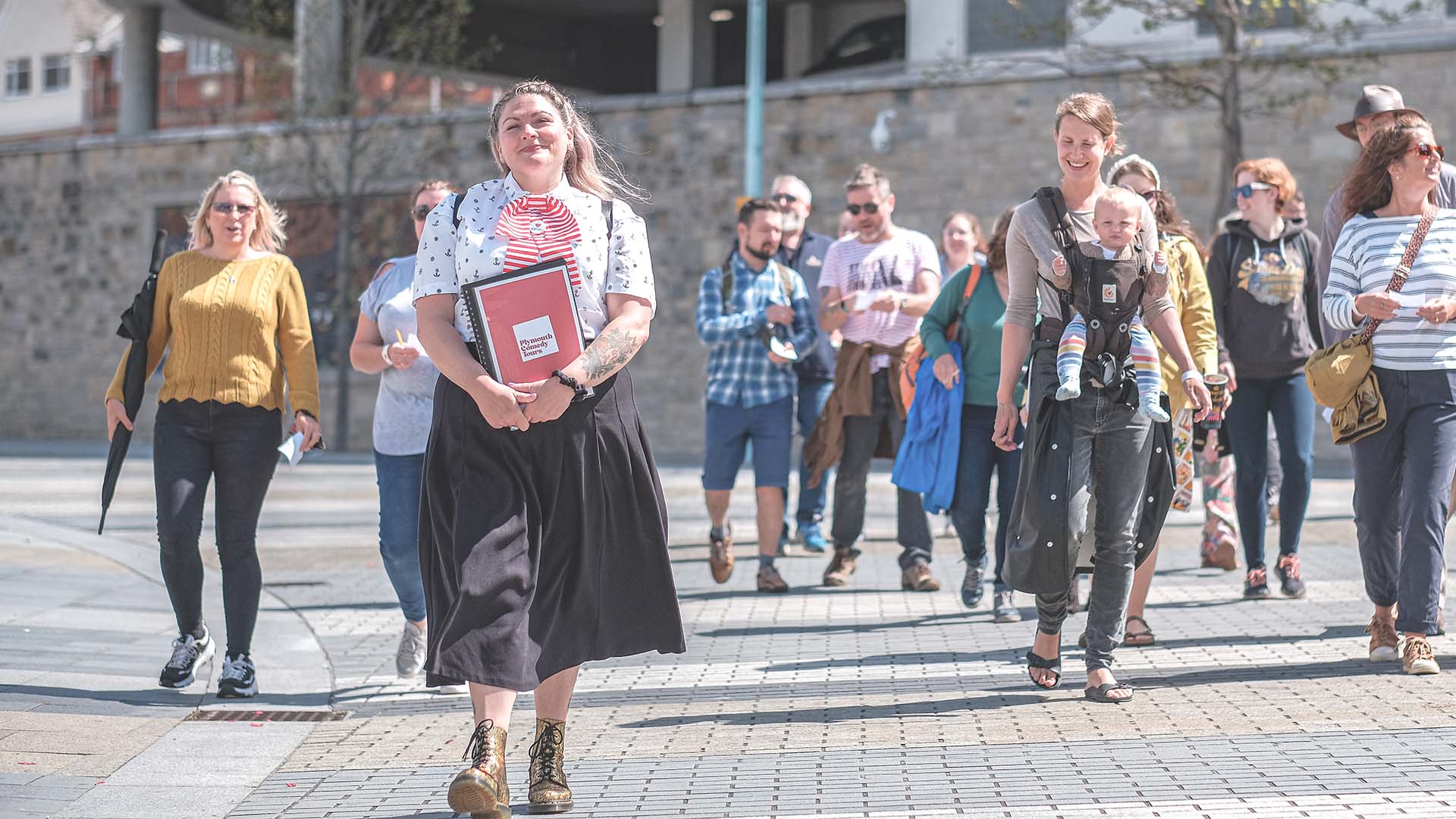 Plymouth Comedy Tours guide Suzy Bennett leading a group of happy tourists.